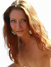 Natural petite redhead teen posing naked in the field